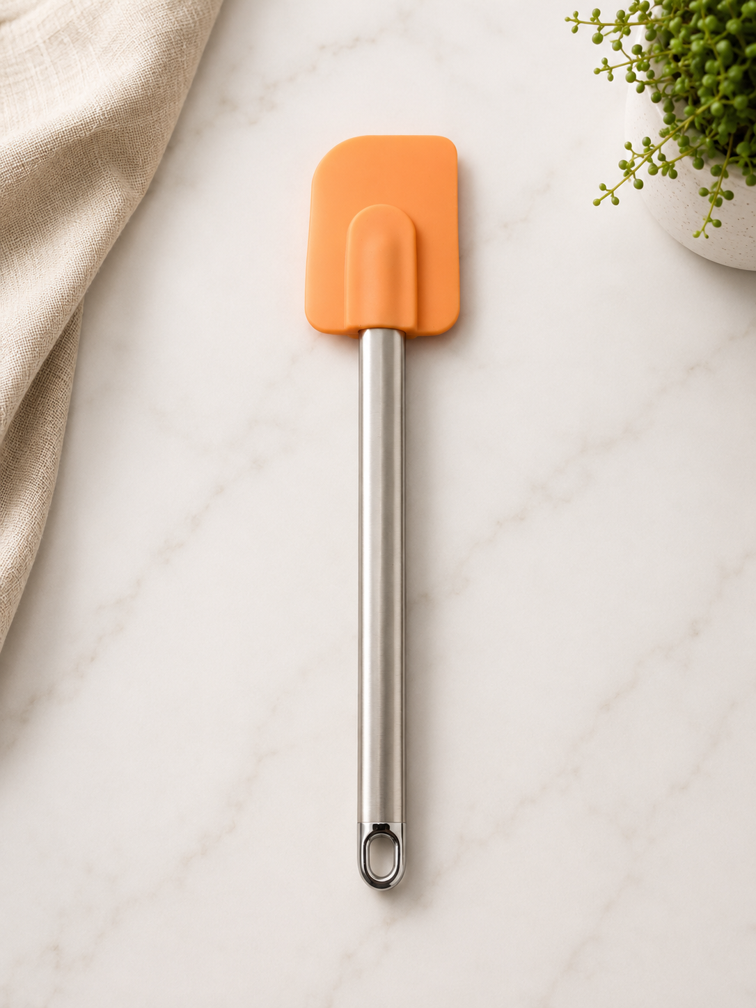 Stainless steel and silicone spatula with an orange head